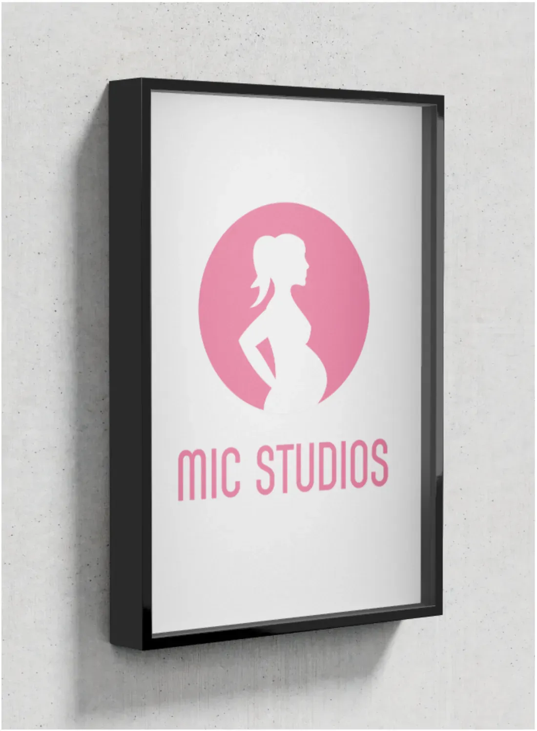 Framed MIC Studios logo print on a concrete wall