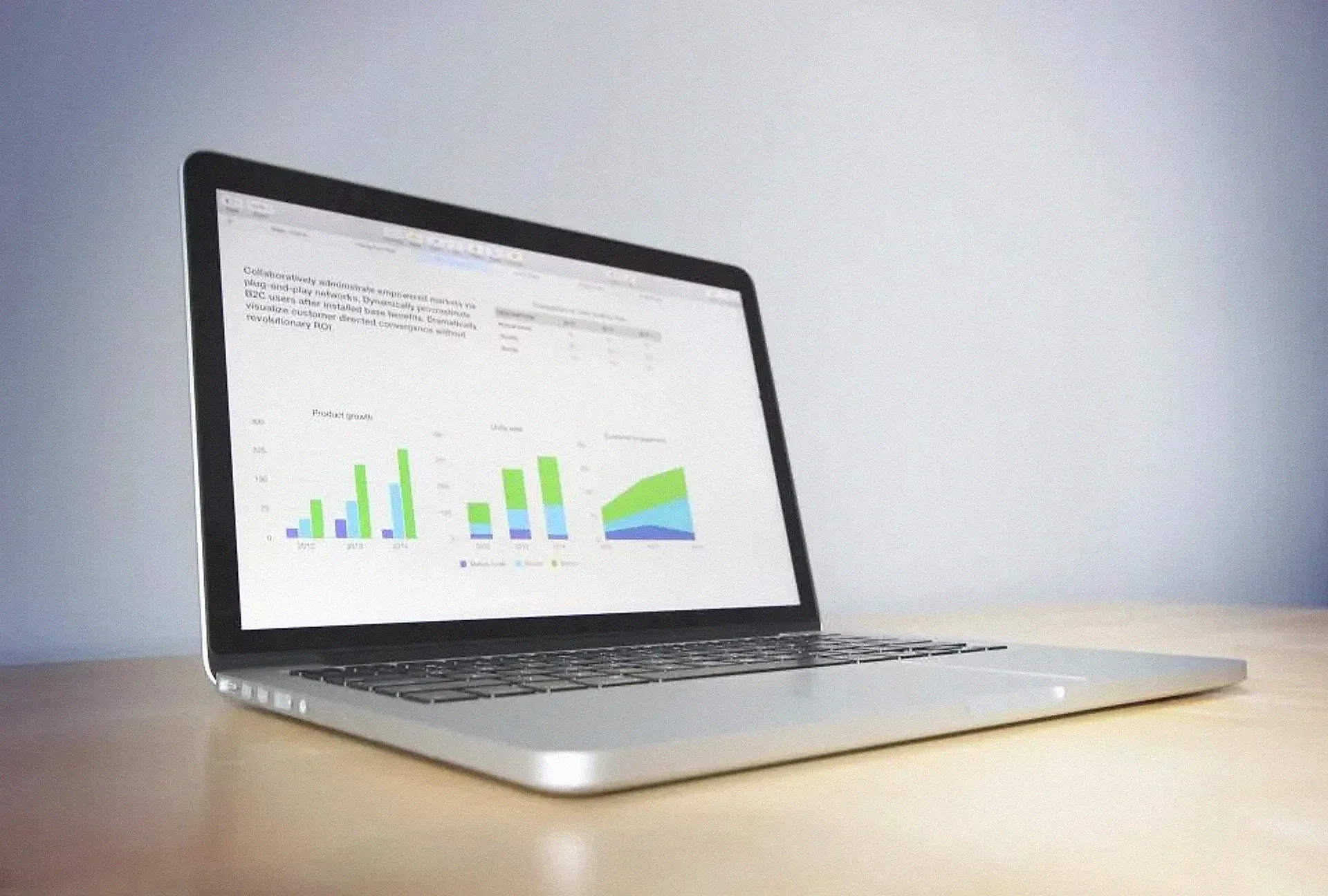 A laptop on a desk showing colourful performance charts